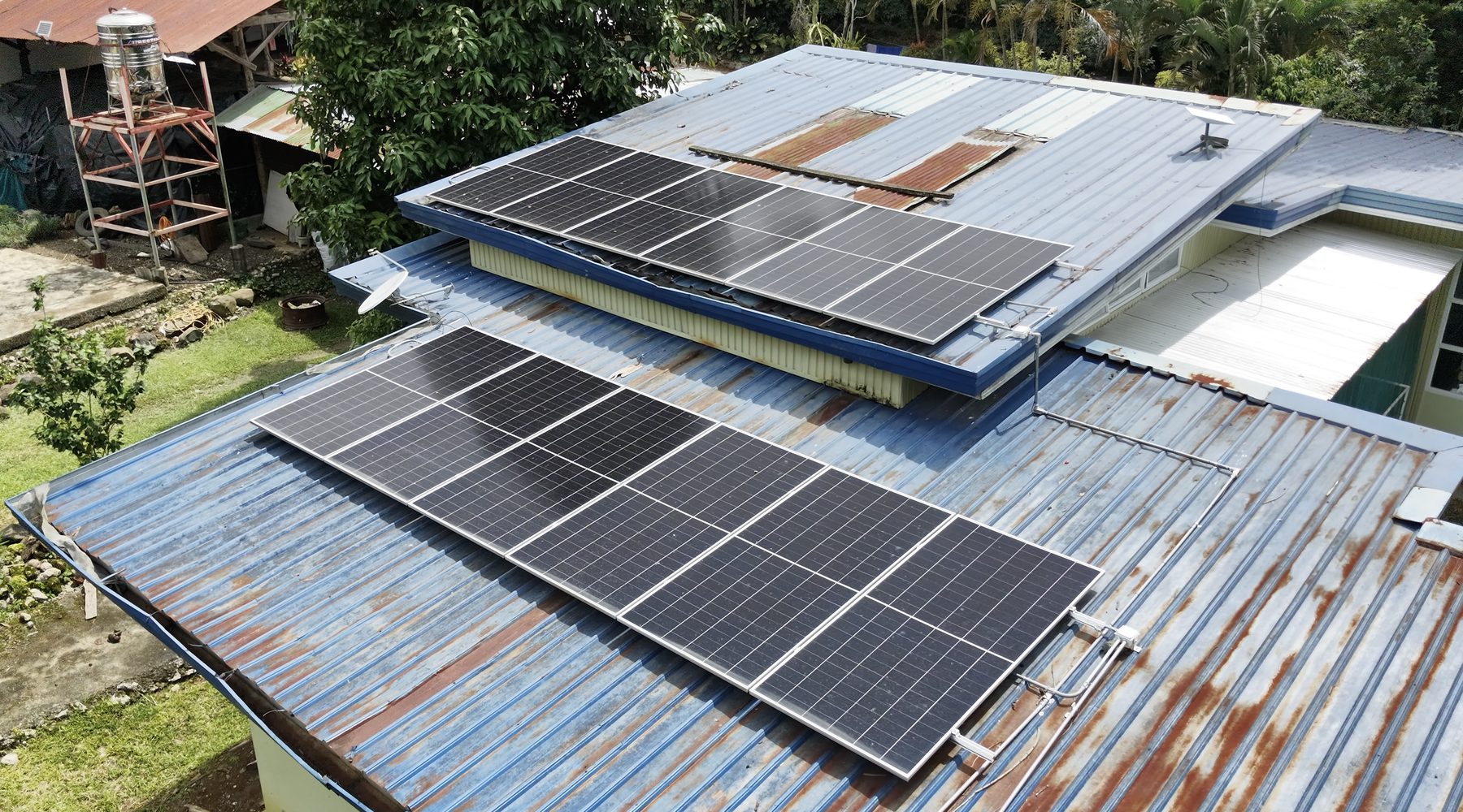 Twelve solar panels on the roof of Atugan Nature Farm