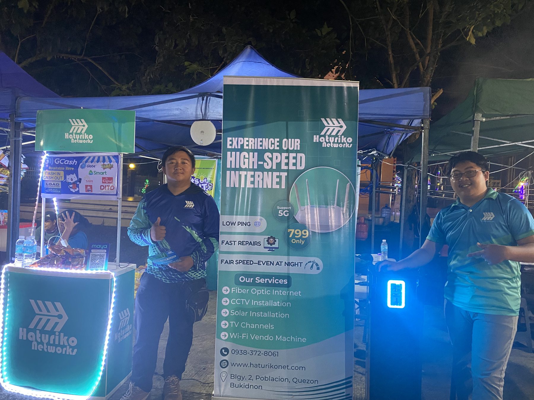 Two Haturiko Networks team members at the ISP booth in the evening