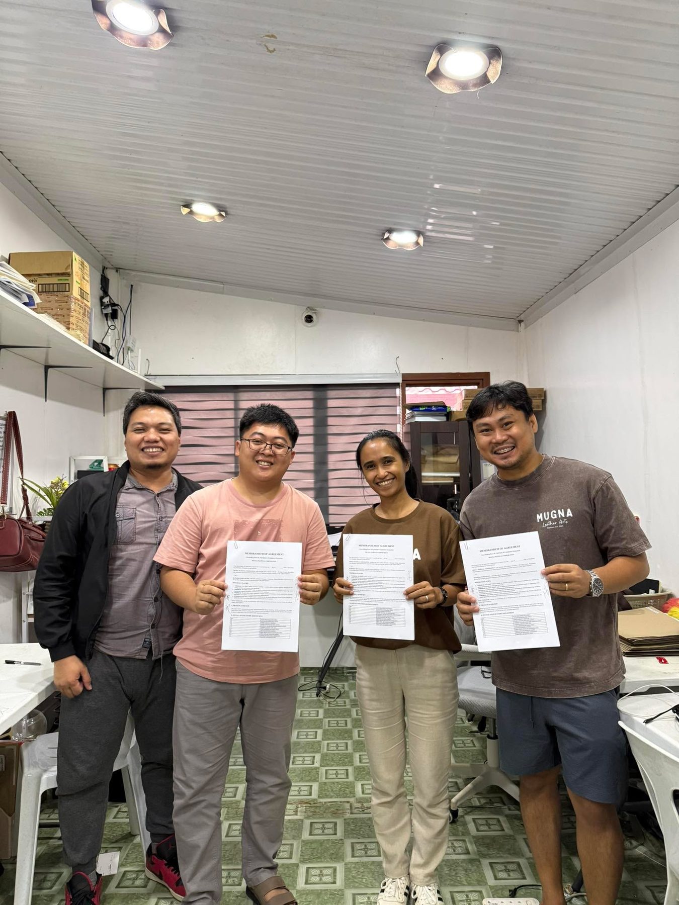 Haturiko and Mugna Leather Arts teams holding the signed agreement