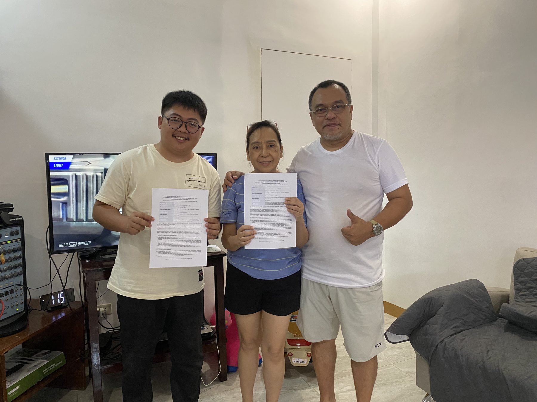 Client and Haturiko team holding the signed documents at Muzic Studio