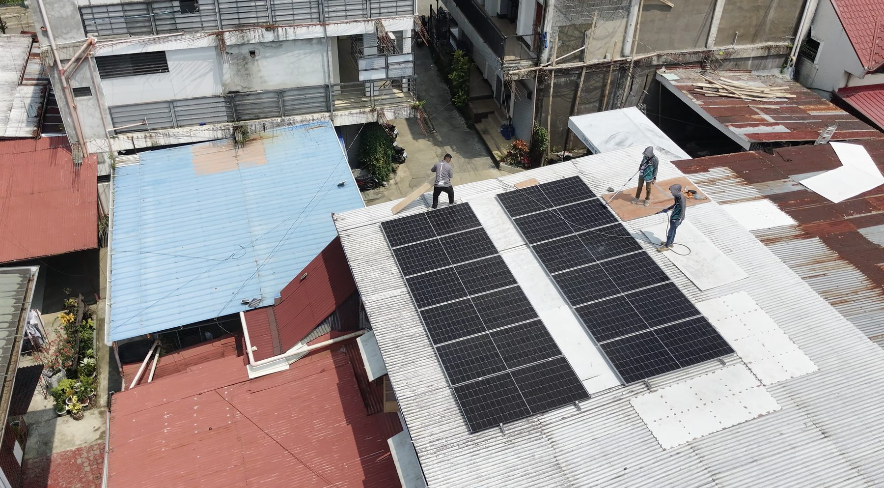Rooftop solar panels being installed on the Muzic Studio building